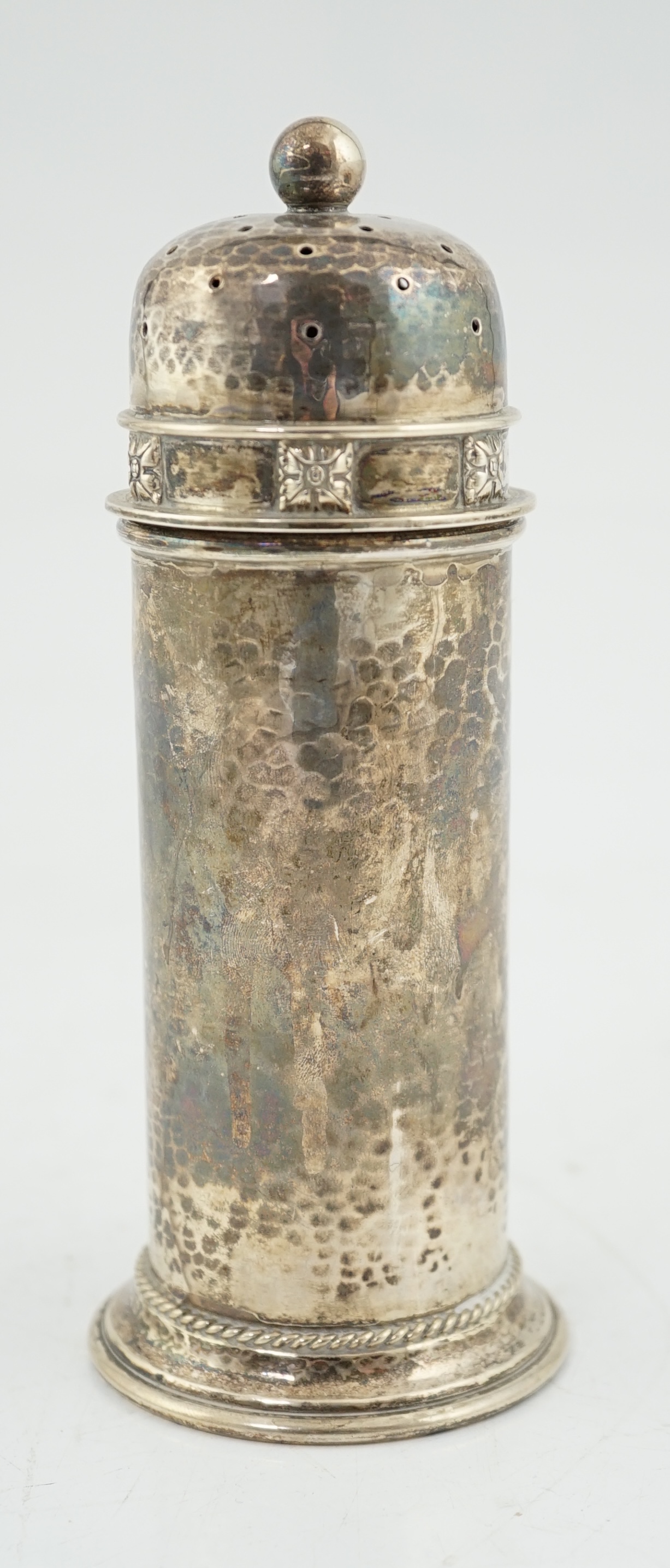 A George V Arts & Crafts planished silver sugar castor by Albert Edward Jones, of lighthouse form, Birmingham, 1929, 16.7cm, 5.3oz. Condition - fair to good